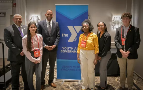 Students standing with Dave Brown and Antonio Delgado