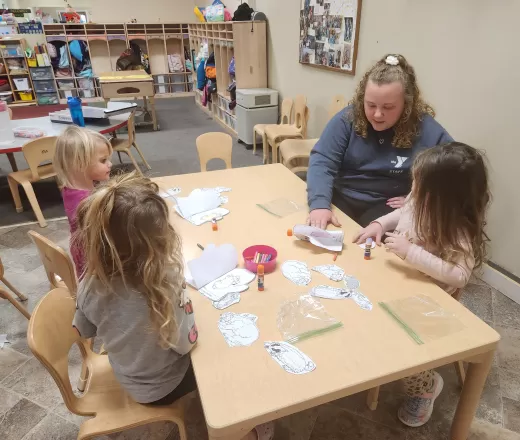 Teacher at table with students