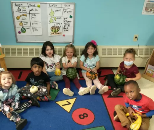 children sitting with gourds
