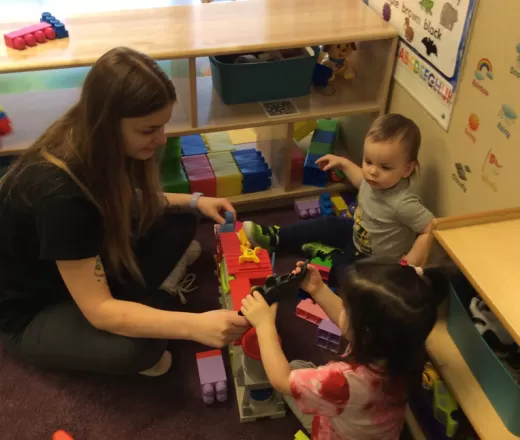 teacher playing legos with toddlers
