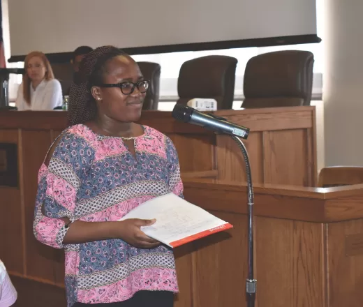 student speaking into microphone