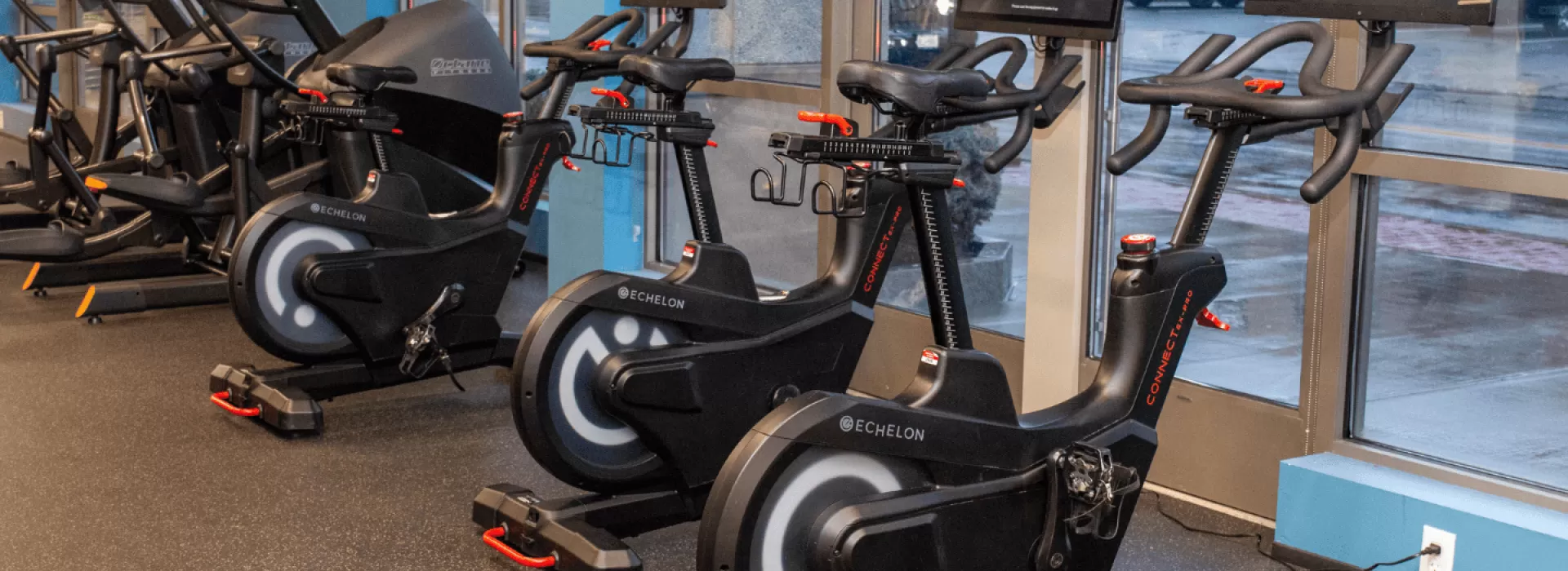 Eschelon indoor cycles lined up along window wall